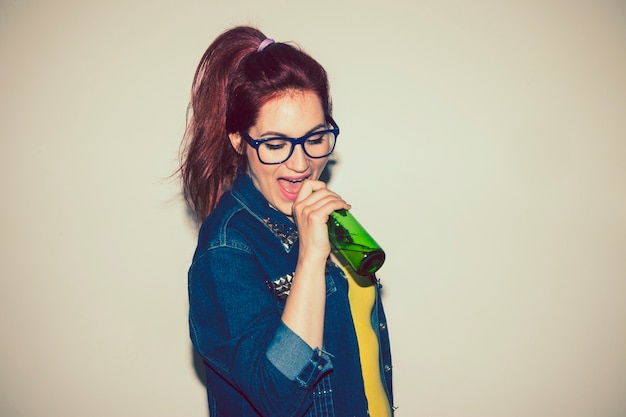 Free Photo singing with a bottle of beer as microphone