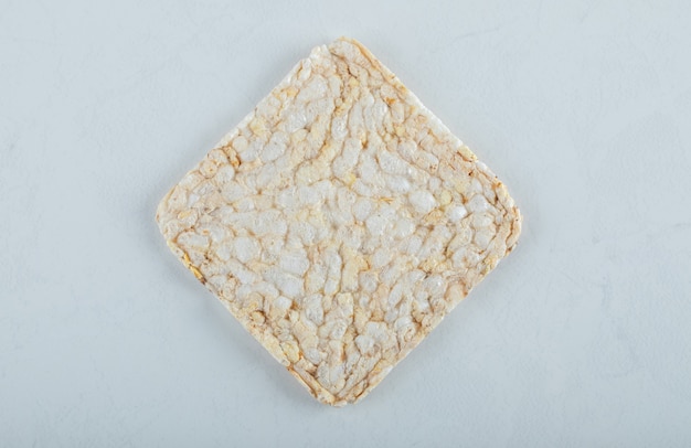 Single airy crispbread on white.