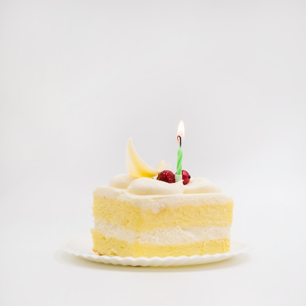 Free photo single candle over the cake slice against white background