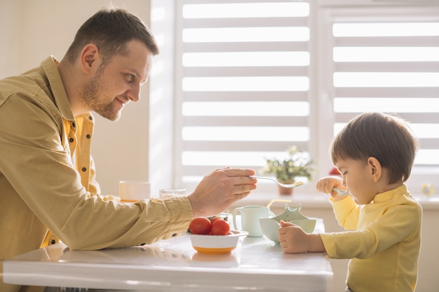 Single-father and child eating breakfast