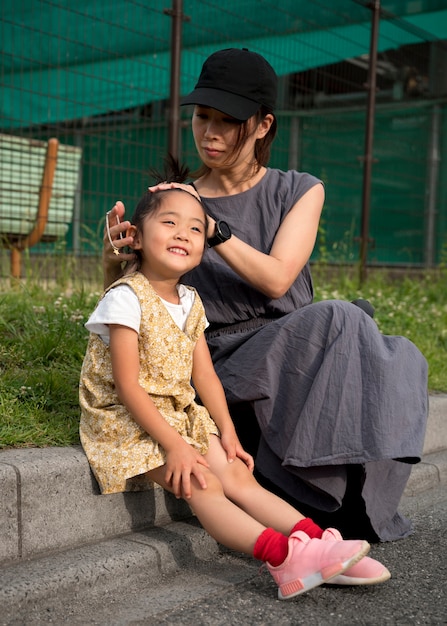 Single mother playing with her daughter in a park