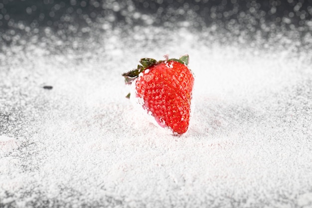 A single stawberry on the flour