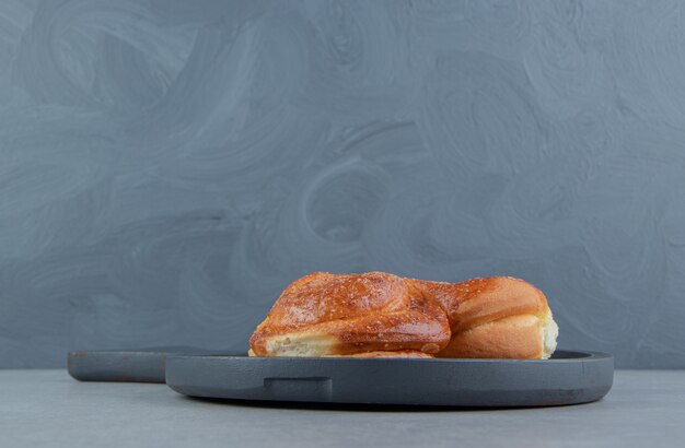 Single sweet pastry on black board. 