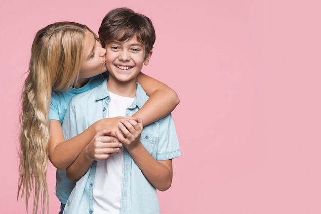 Sister kissing brother on cheek