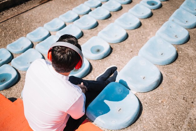 Sitting man using earphones