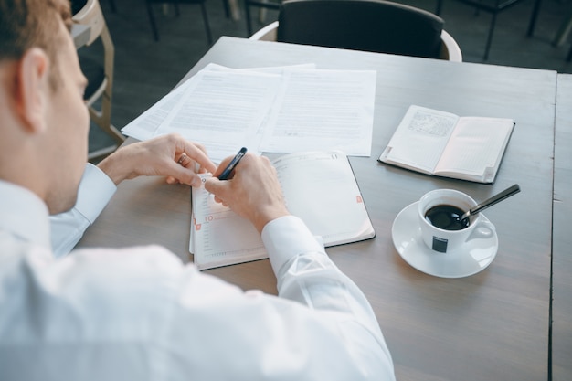 sitting pen businessman information person