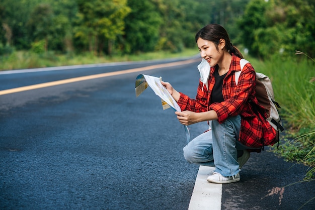 Free photo sitting and watching the map on the road.