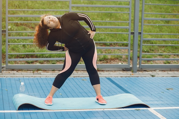 Free photo over the size of a woman doing stretching exercises