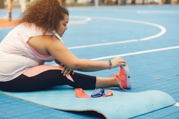 Free photo over the size of a woman doing stretching exercises