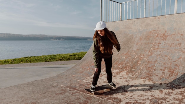 Skateboarder girl on the ramp long shot