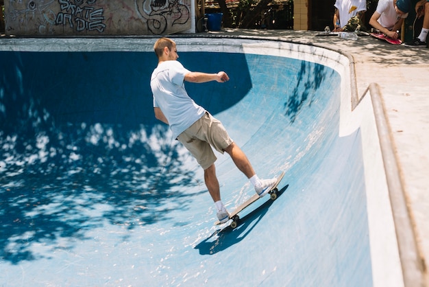 Skateboarder on ramp in sunny day