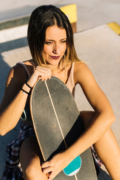 Skater girl holding her board