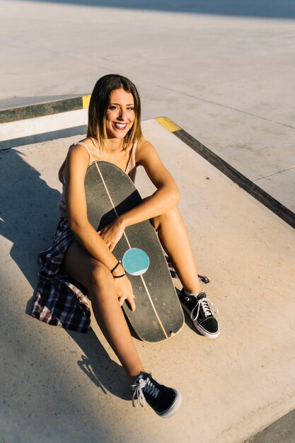 Skater girl sitting and smiling