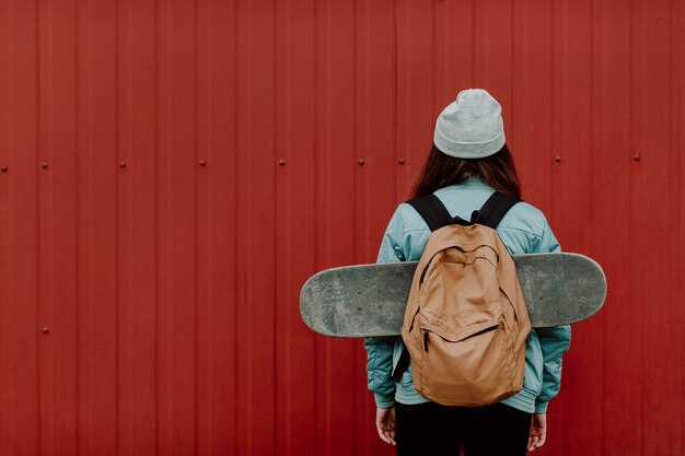 Skater girl in the urban from behind copy space