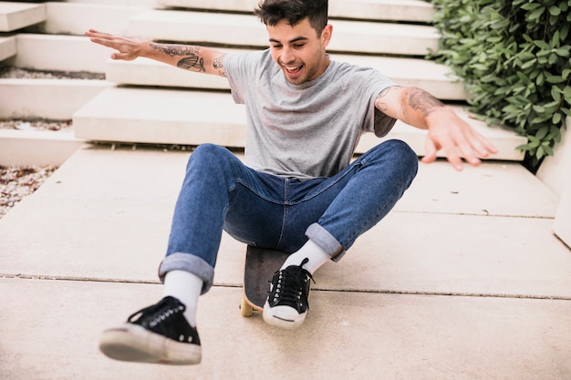 Skater performing with long board outdoors