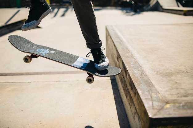 Free photo skater's legs with skateboard and big jump