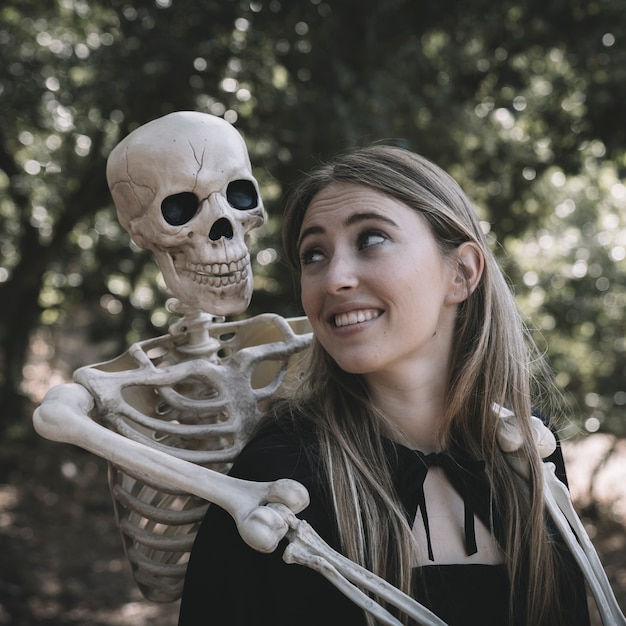 Free photo skeleton hugging behind lady