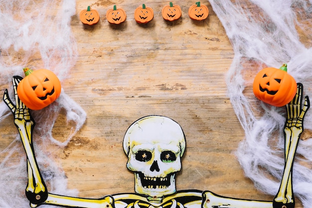 Free photo skeleton made of paper and little pumpkins