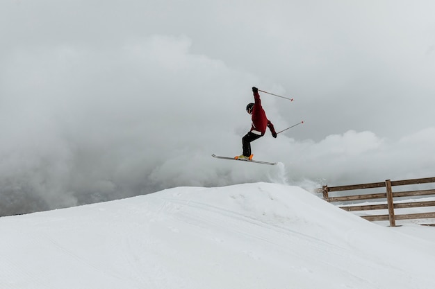 Free Photo skier jumping over hill long shot