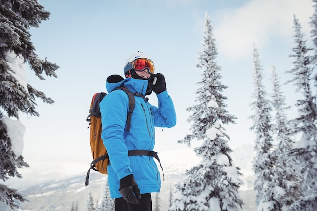 Skier talking on mobile phone