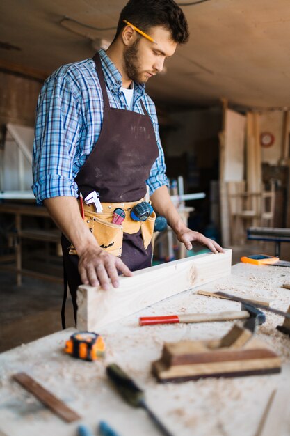 Skillful carpenter wrapped up in work