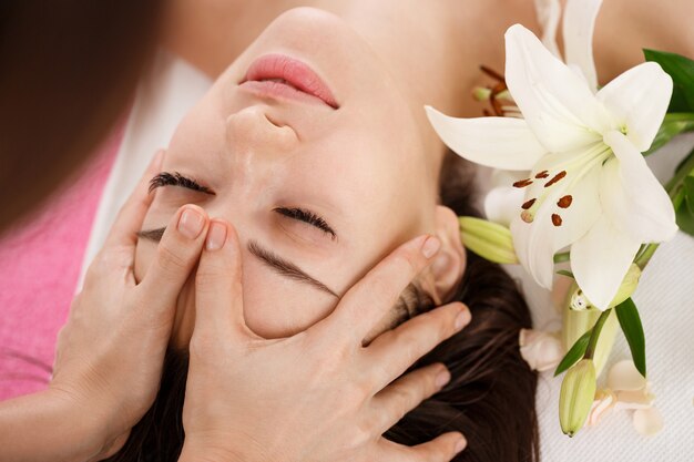 Skin and body care. Young woman getting face massage. Facial beuty