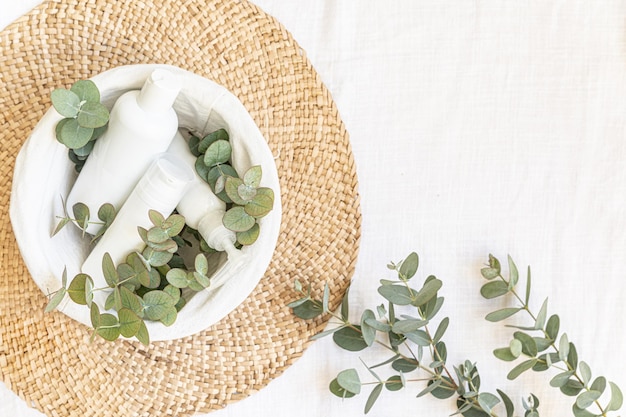 Skin care concept with white bottle and palm leaves on tropical background