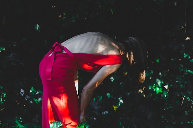 Free photo skinny woman looking at ground in garden