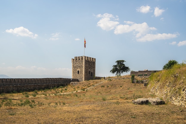 Skopje Fortress surrounded by grass and trees under sunlight in North Macedonia