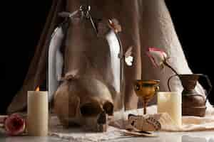 Free photo skull and candle arrangement still life