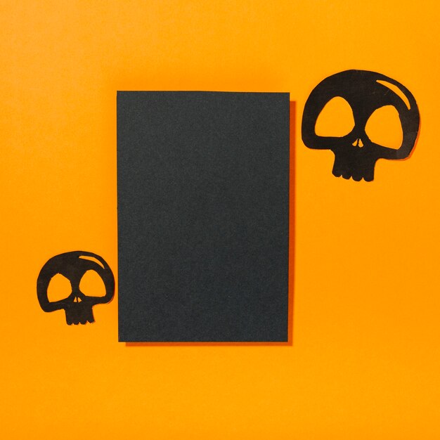 Skulls laid near piece of black paper