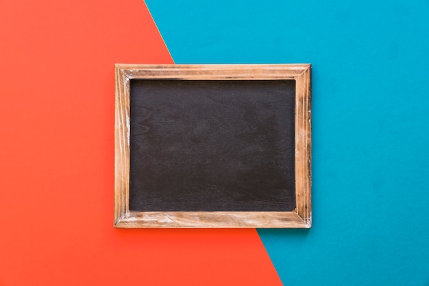 Slate with wooden border on red and blue background