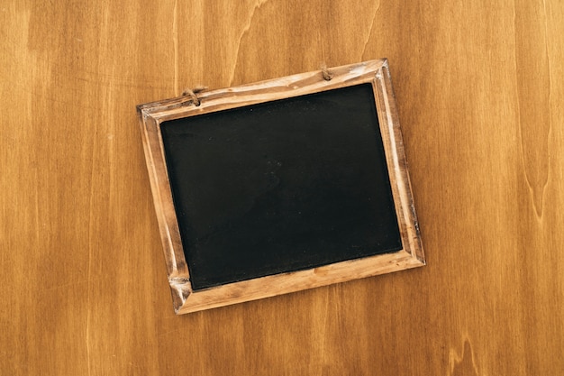 Free photo slate on wooden surface