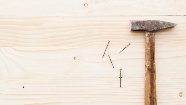 Sledgehammer with nails on table 