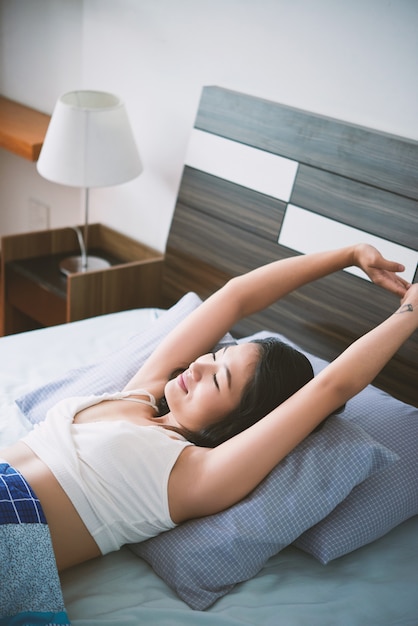 Free Photo sleeping woman stretching in morning time