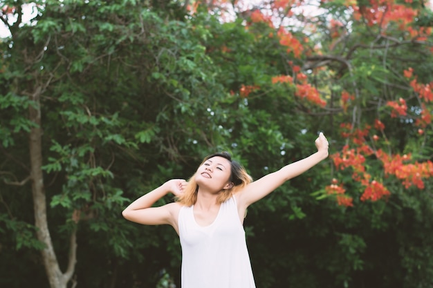 Sleepy girl stretching with trees background