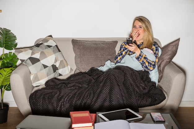 Free photo sleepy mother with baby watching tv