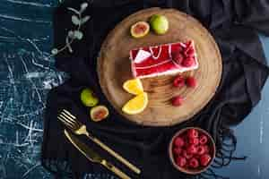 Free photo a slice of berry cake in a white plate, top view.