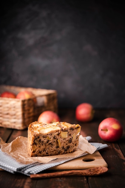 Free photo slice of cake with apples and wooden spoon