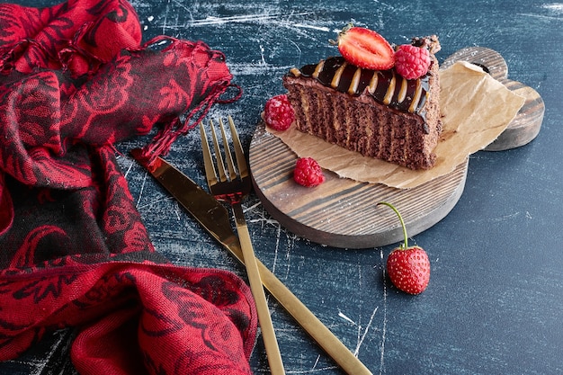 A slice of chocolate cake with strawberries. 