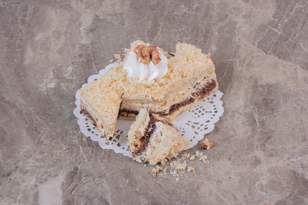 Slice of homemade cake on marble table.