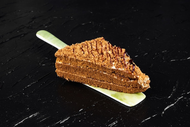 A slice of honey cake on the spatula. 