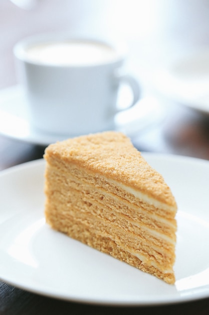 A slice of honey cake with a cup of milk