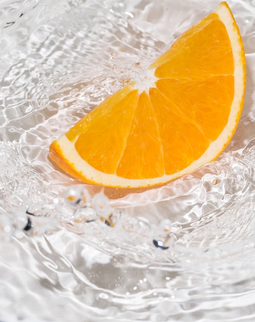 Free Photo slice of an orange in water