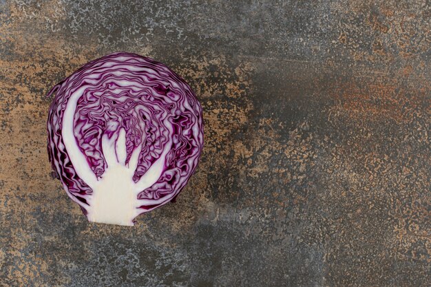 A slice of red cabbage on the marble surface