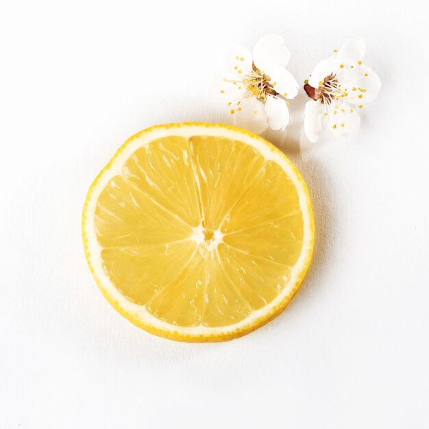 Slice ripe lemon citrus fruit on a white.