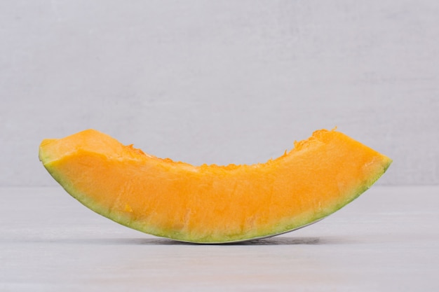 Slice of white pumpkin on white.