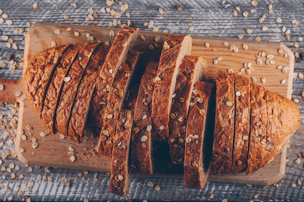 Sliced bread on a cutting board on a wooden surface