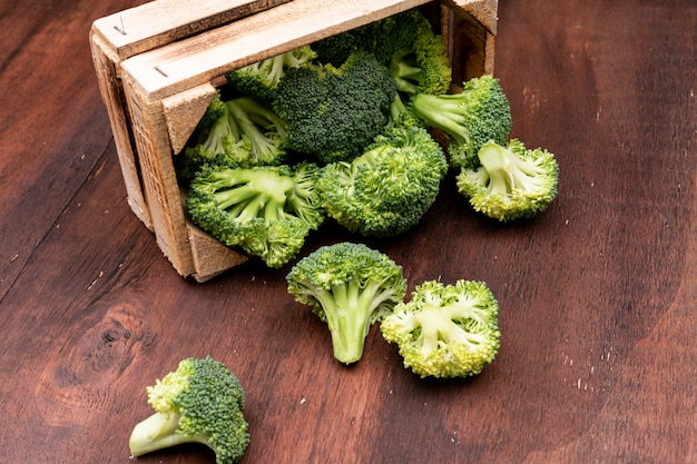 Free Photo sliced broccoli in wooden box on wooden floor