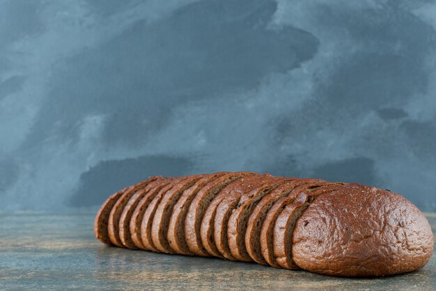 Sliced brown bread on marble background